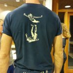 White/yellow on dark blue t-shirt.