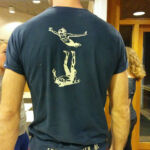 White/yellow on dark blue t-shirt.
